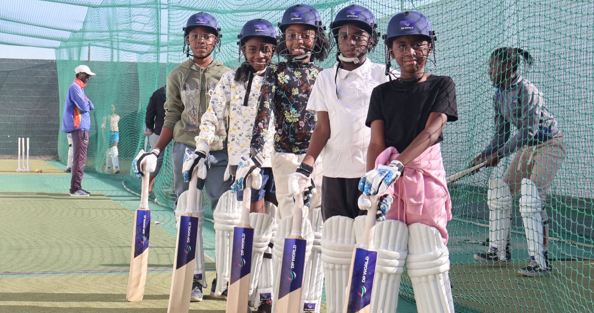 Group of young cricketers practicing on a cricket field in Namibia.