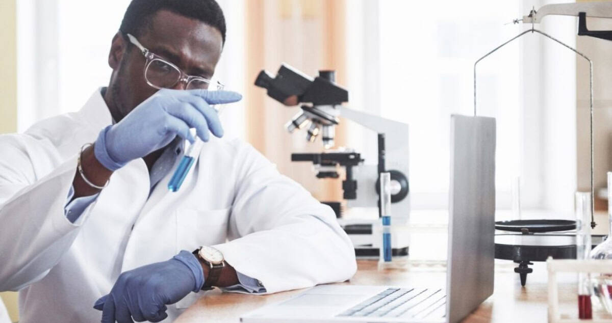 Researcher performing diagnostic testing in Africa's healthcare crisis.