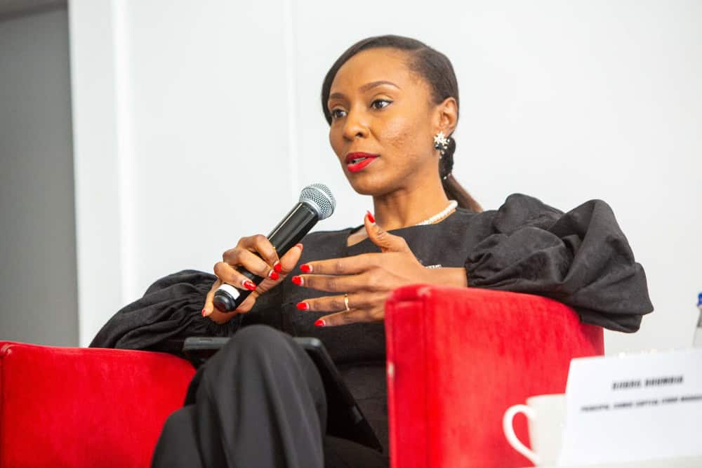 African woman speaking into a microphone at a conference on regional financial hubs.