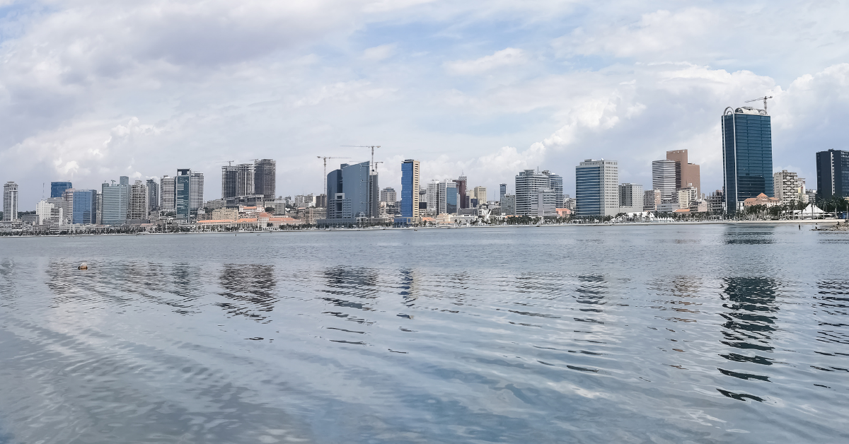 Modern city skyline with waterfront view in Angola, highlighting urban growth amid economic challeng.