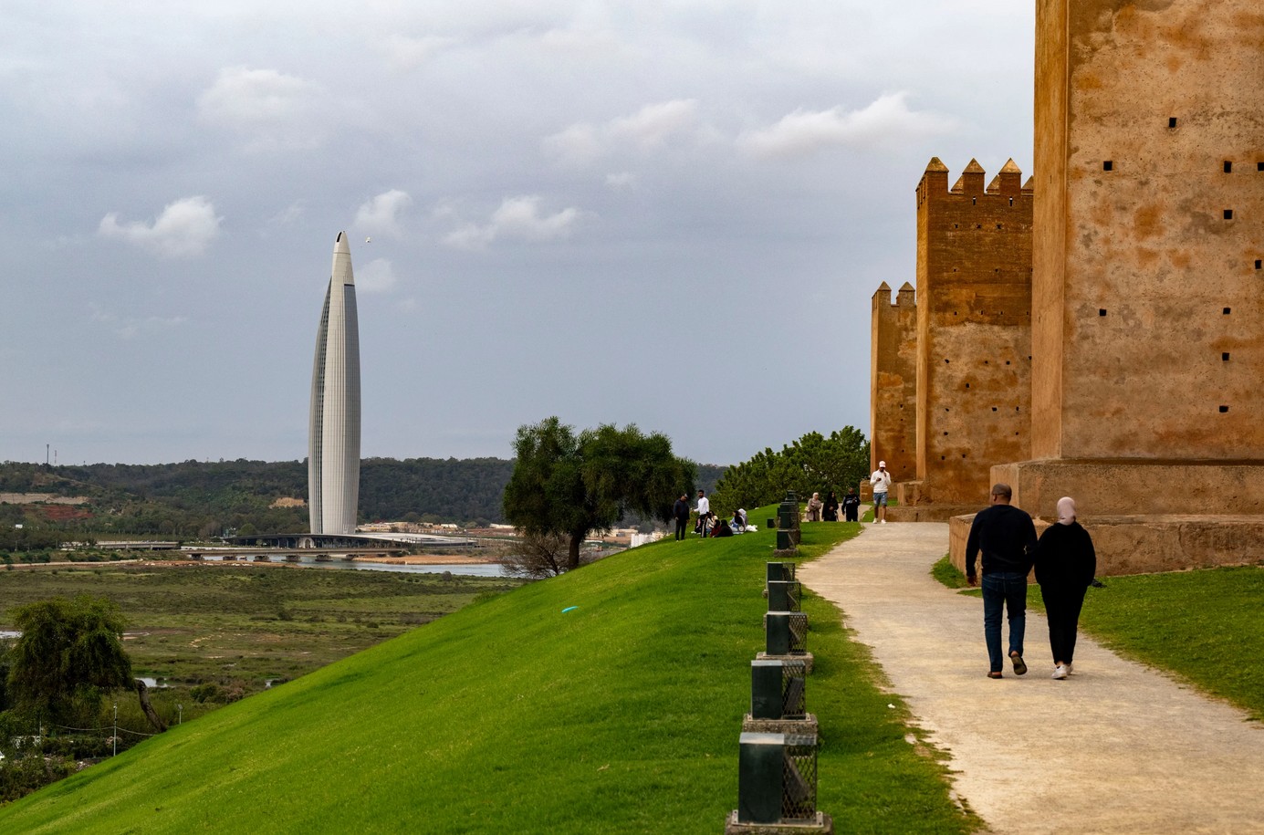 Historic Kasbah fortress in Morocco with modern cityscape in the background.