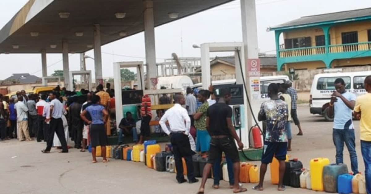 People line up to refuel vehicles during fuel supply limitations.