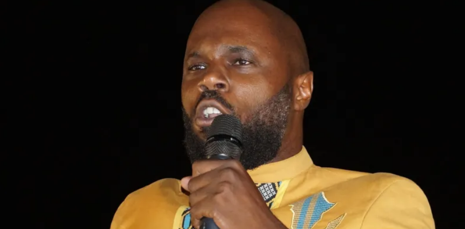 Kemi Seba delivering a speech at a public event.