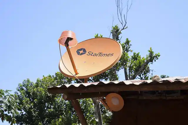 Satellite dish on a rooftop in Africa, symbolizing digital connectivity and communication infrastruc.