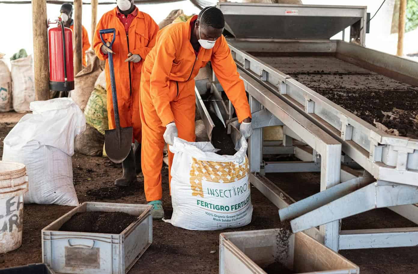 African workers handling fertilizer production to address fertilizer shortages.
