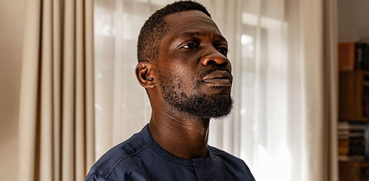 African man with serious expression in a well-lit room.