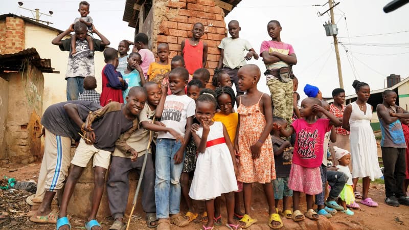 Children and community members gather in an African neighborhood.