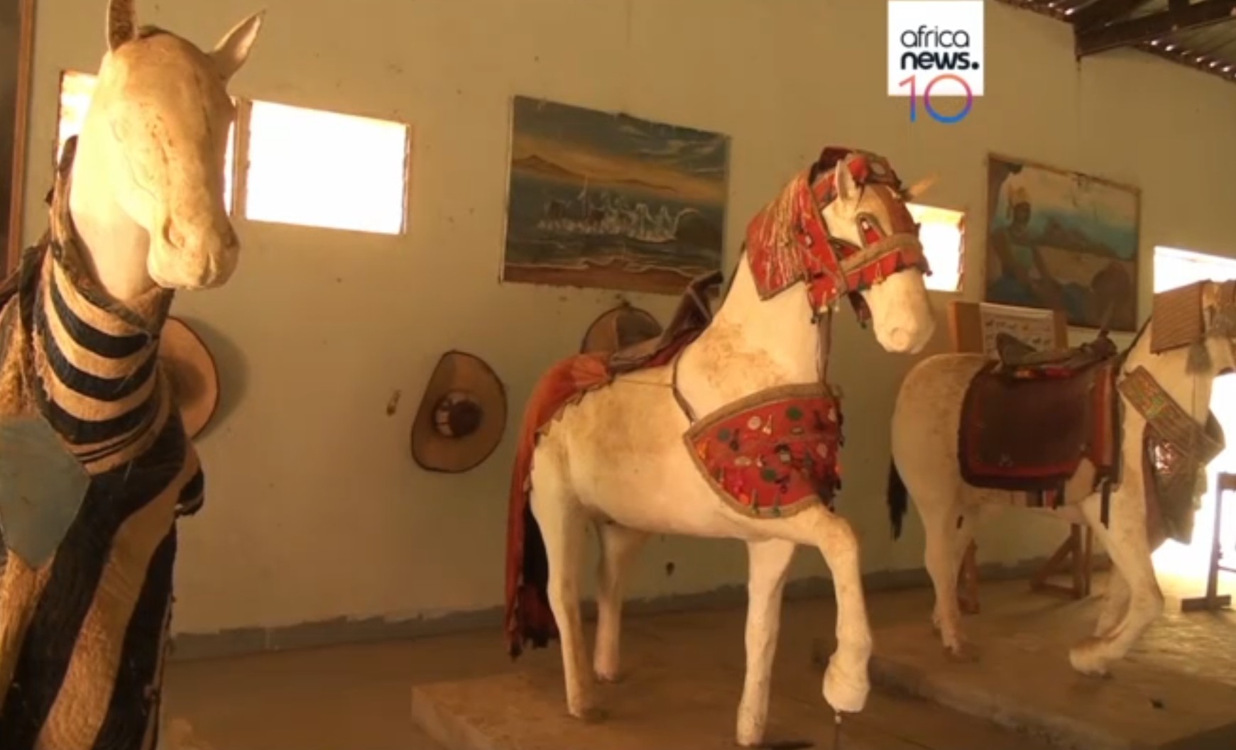 Colorful handcrafted horse figurines with intricate designs and accessories.
