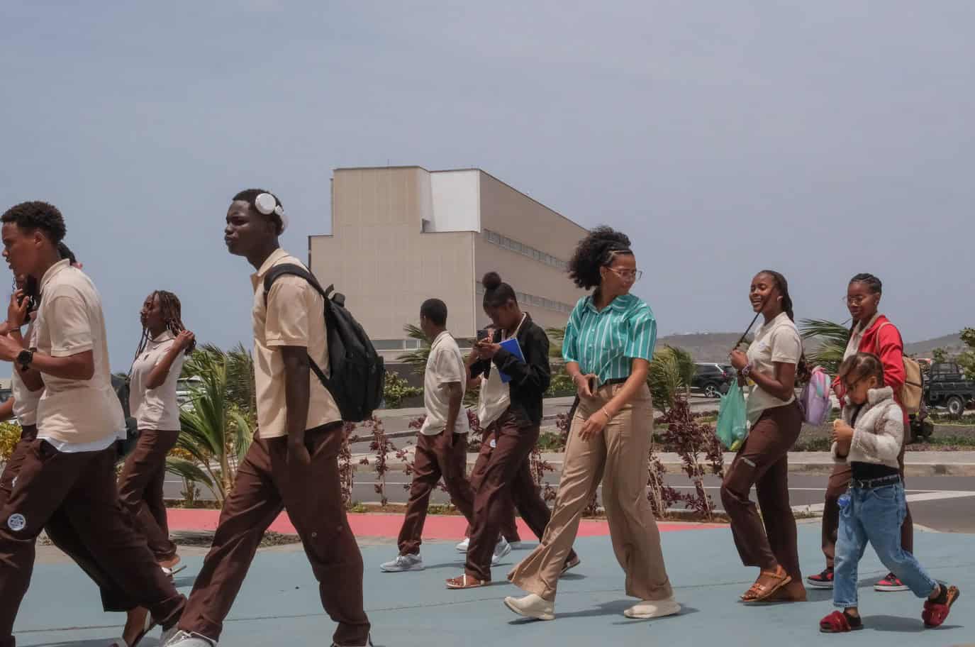 Students walking outdoors at a school campus in Africa.