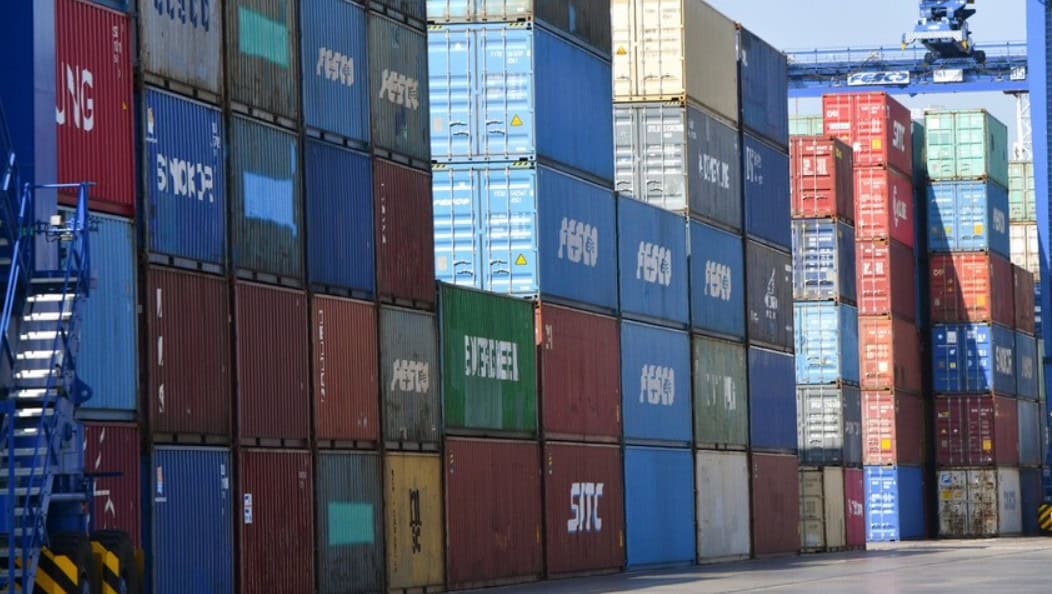 Shipping containers stacked at African port amid trade expansion.
