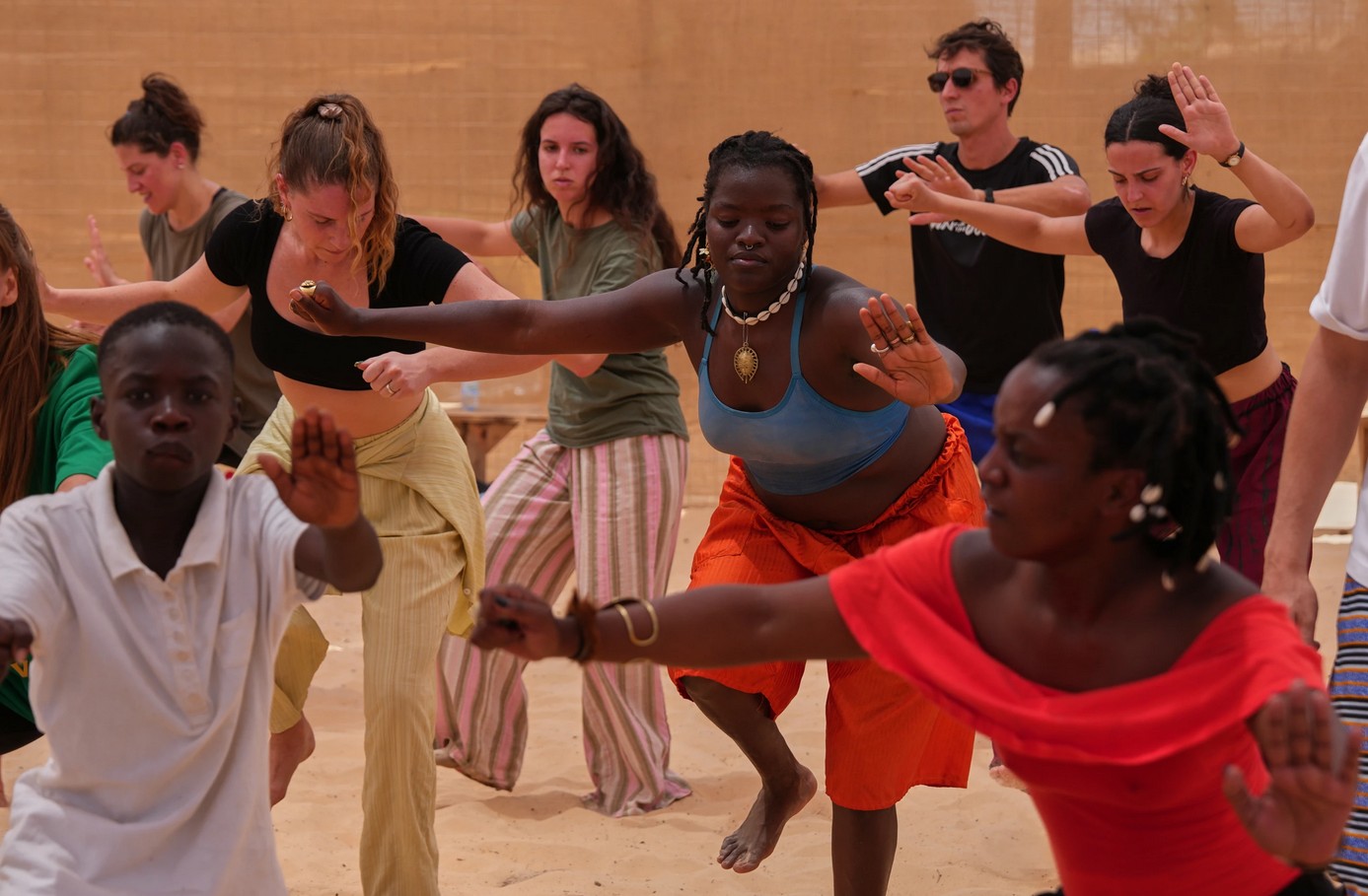 Dance workshop in Africa with diverse participants practicing traditional moves.
