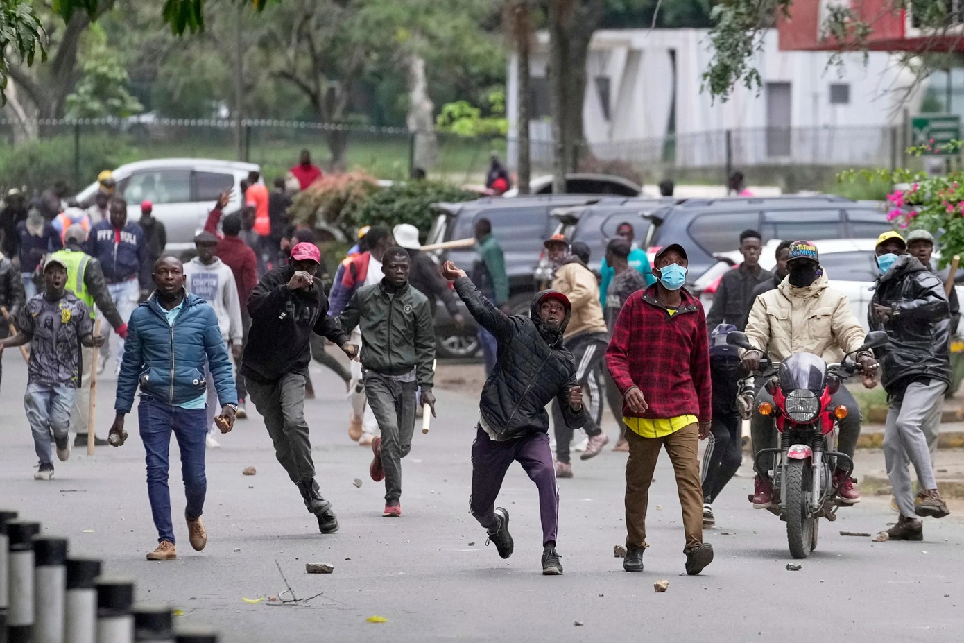 People protesting in the streets of an urban area in Africa.