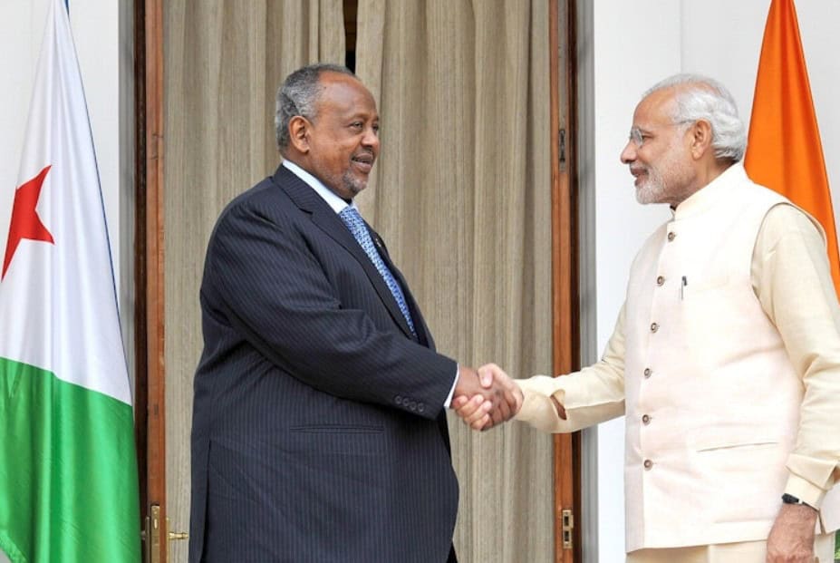 Two African leaders shaking hands during a diplomatic meeting.