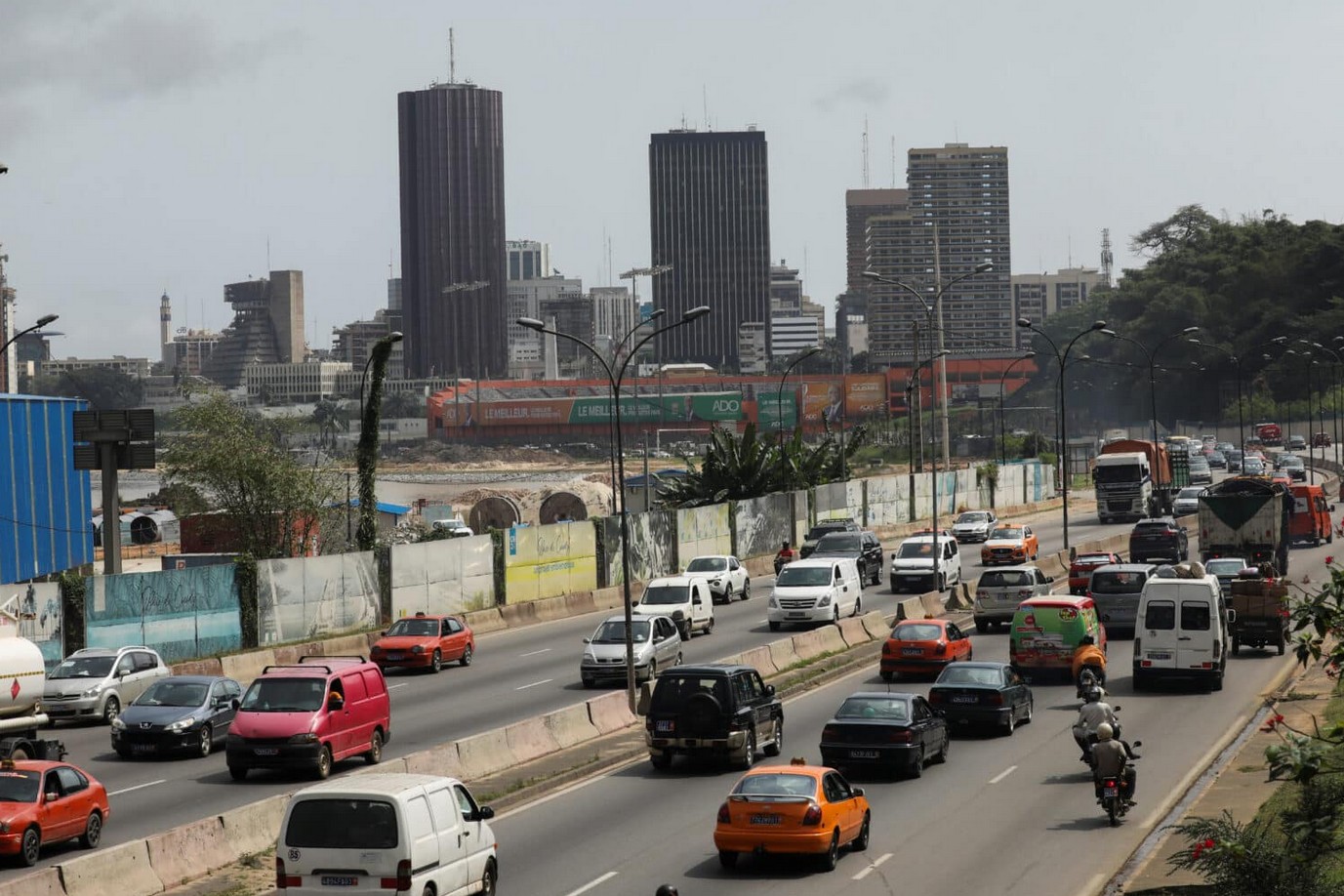 Urban traffic scene in Nairobi with cars, buses, and motorcycles on a busy city road.