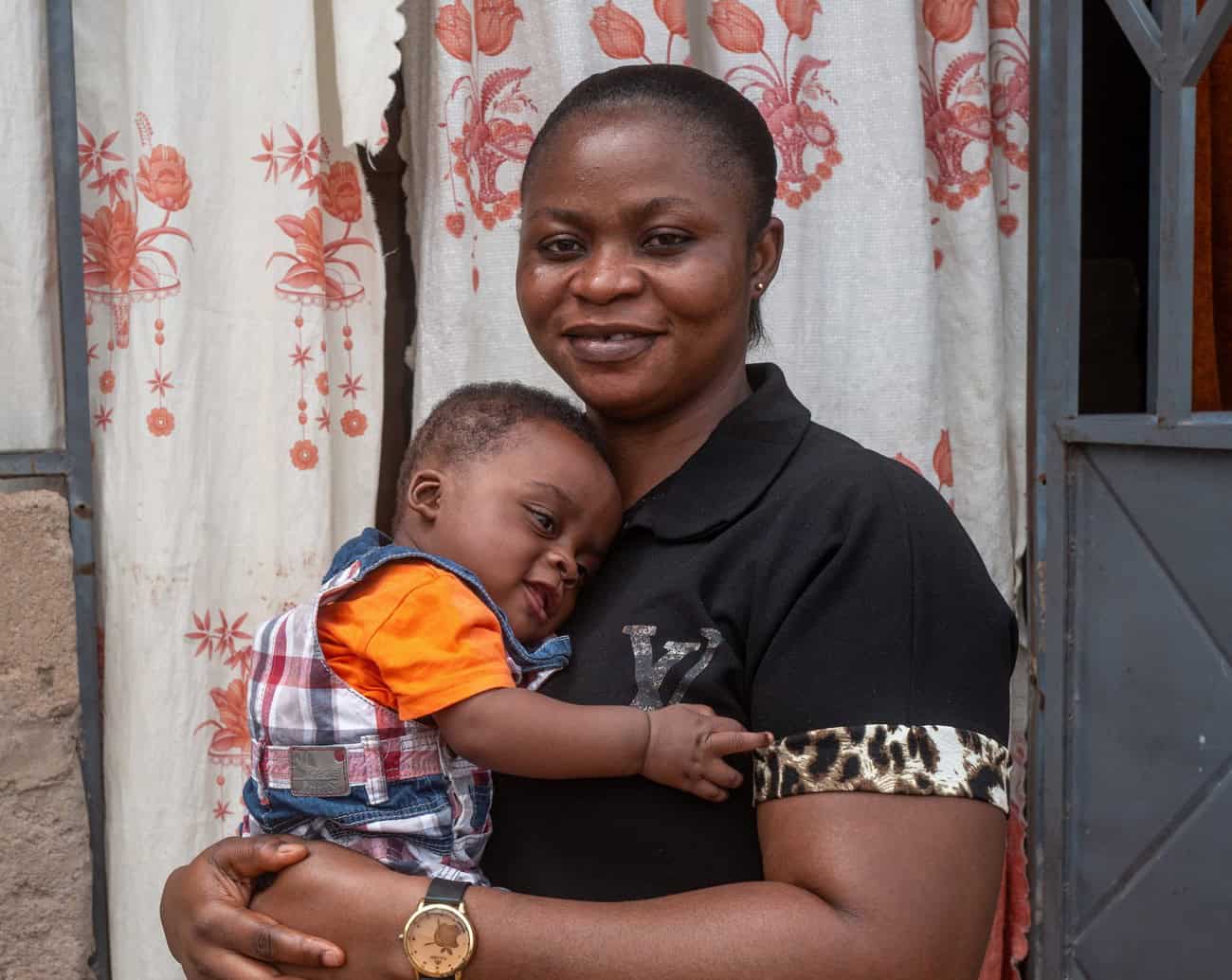 African woman holding her young child with love and care.