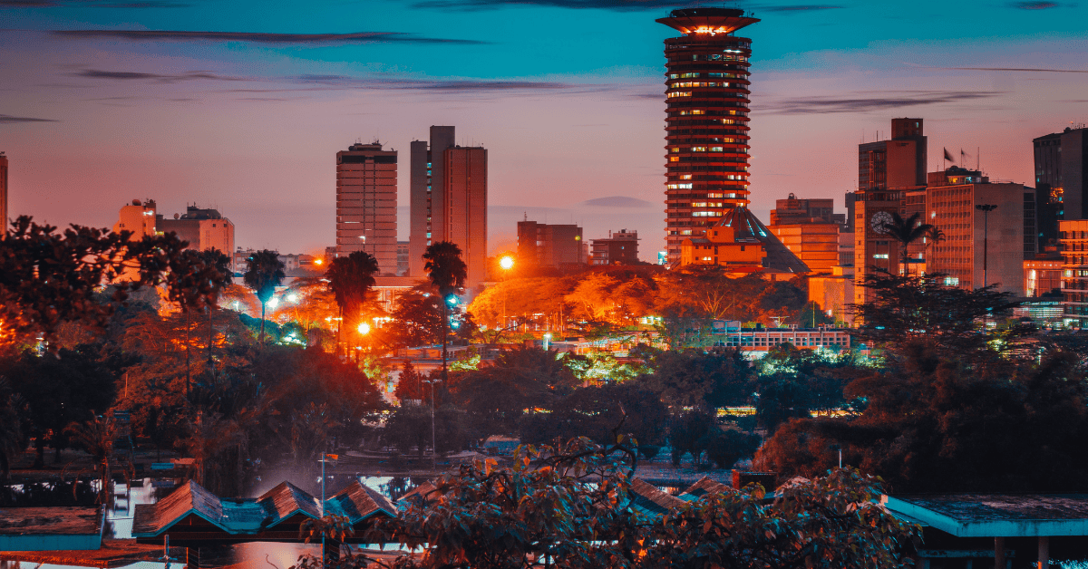 Nairobi cityscape with tall buildings and vibrant sunset colors.