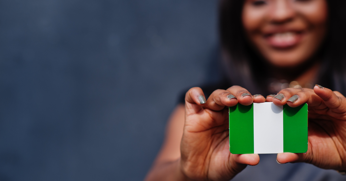 Woman holding Nigeria flag representing political shifts and emerging alliances.