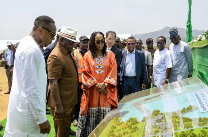 Group of officials viewing an urban planning model in Africa.
