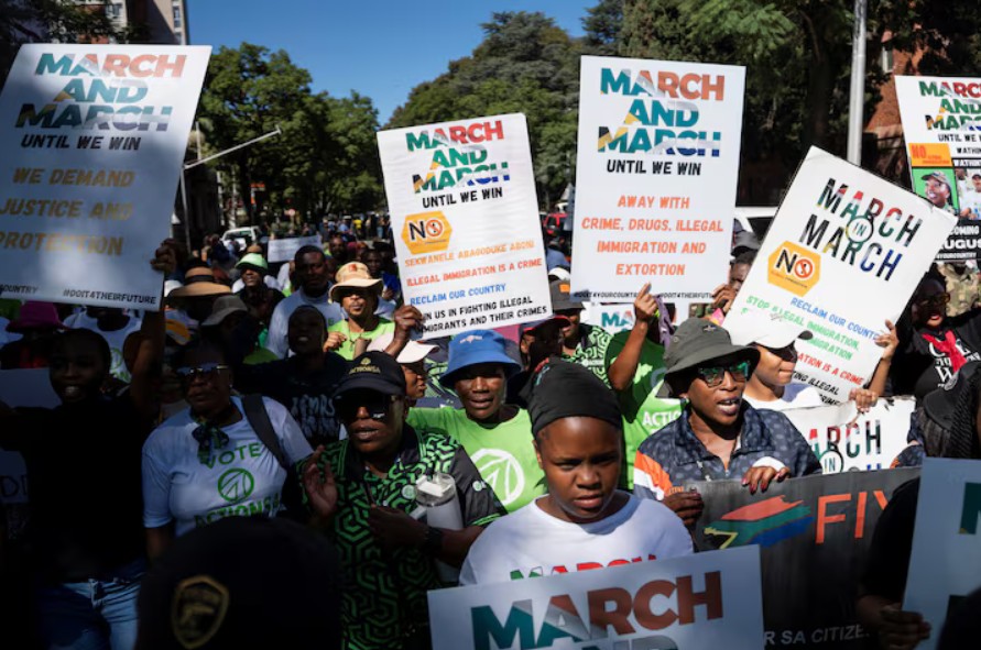Protest rally in Africa with people holding signs demanding justice, anti-corruption, and fair elect.