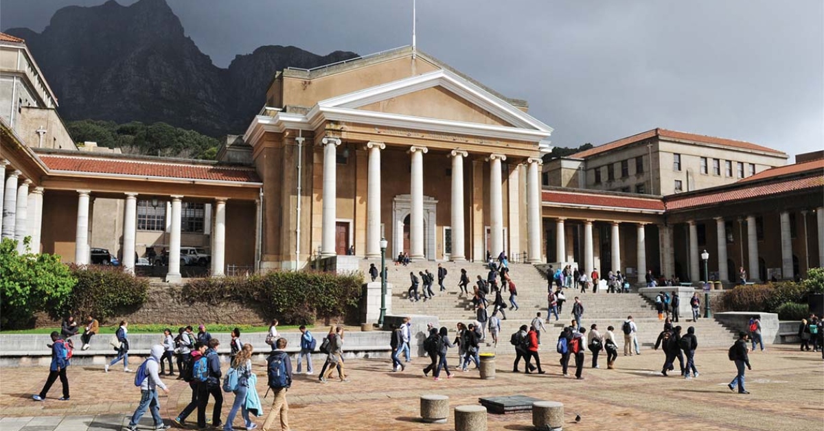 UCT campus with students walking and gathering outside historic buildings.