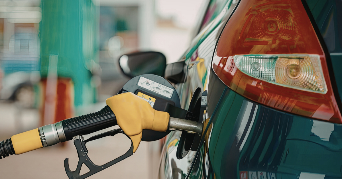 Fuel pump nozzle inserted into a vehicle's fuel tank in South Africa.