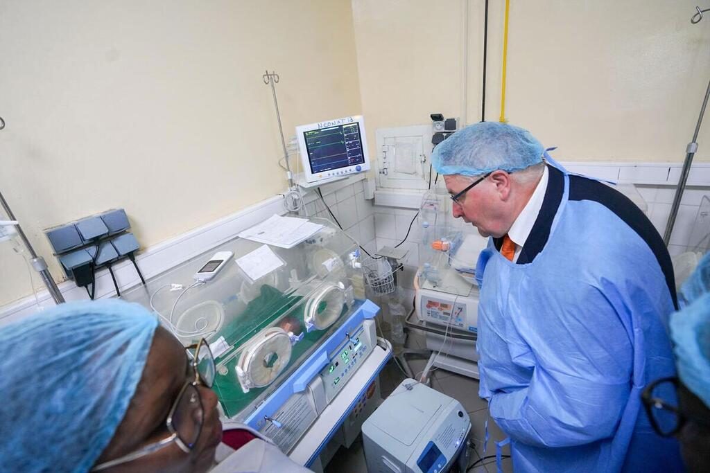 Healthcare professionals monitoring newborns in incubators at a hospital in Africa.