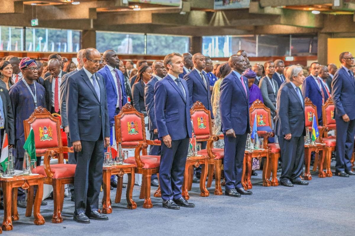 African leaders standing during an international conference in a formal setting.