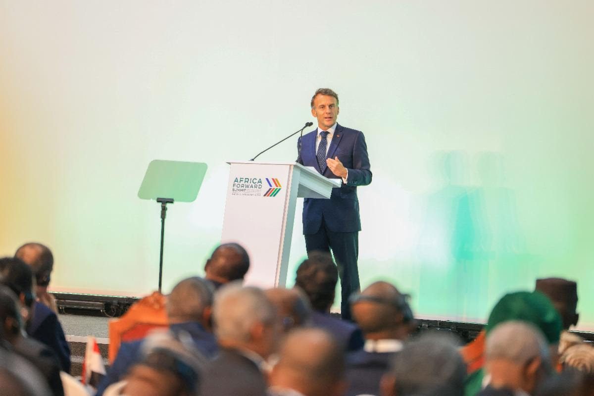 Business conference speaker delivering speech at Africa.com event.