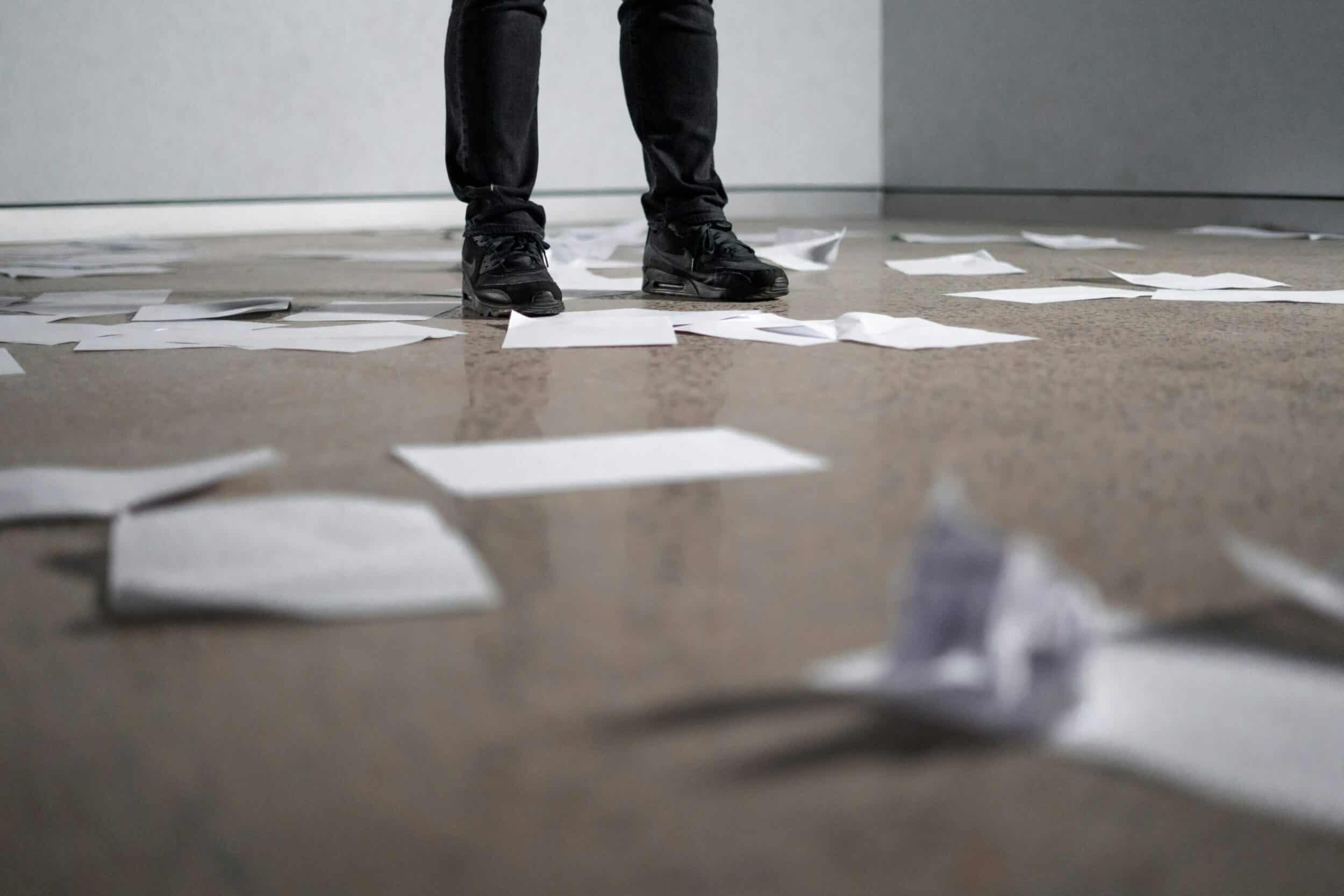 Paper strewn on the floor, working out the process.