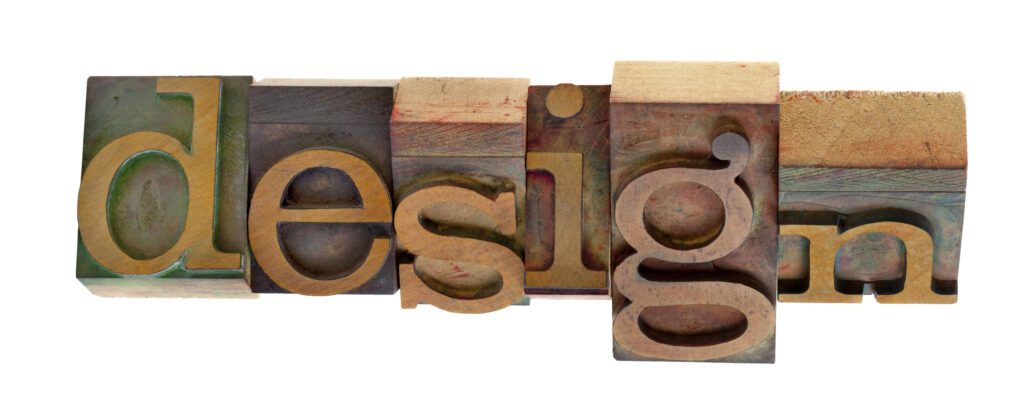 The word "design" spelled out in typographer's wood block type.