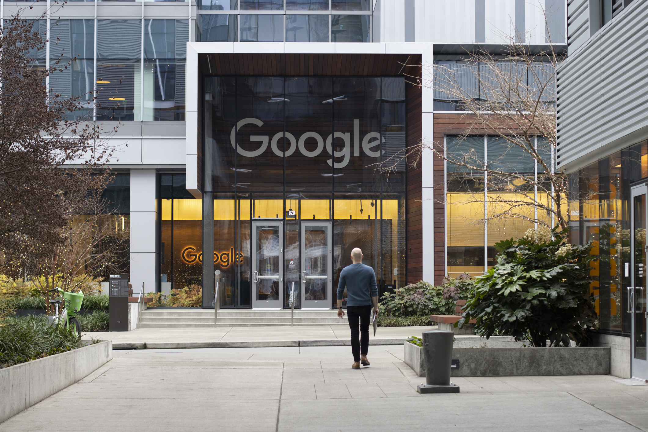 Exterior of Google headquarters building with the Google logo displayed prominently above the entrance, no corporate designation included.Exterior of Google headquarters building with the Google logo displayed prominently above the entrance, no corporate designation included.