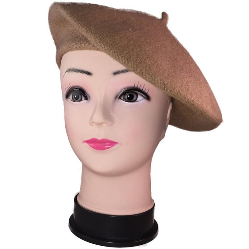 Vintage mannequin head sporting a beige beret cap.