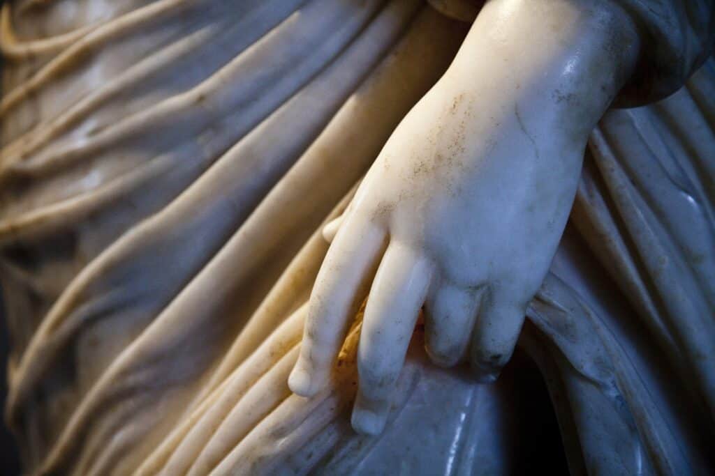 Close up of stone sculpture, detail of an elegant hand.
