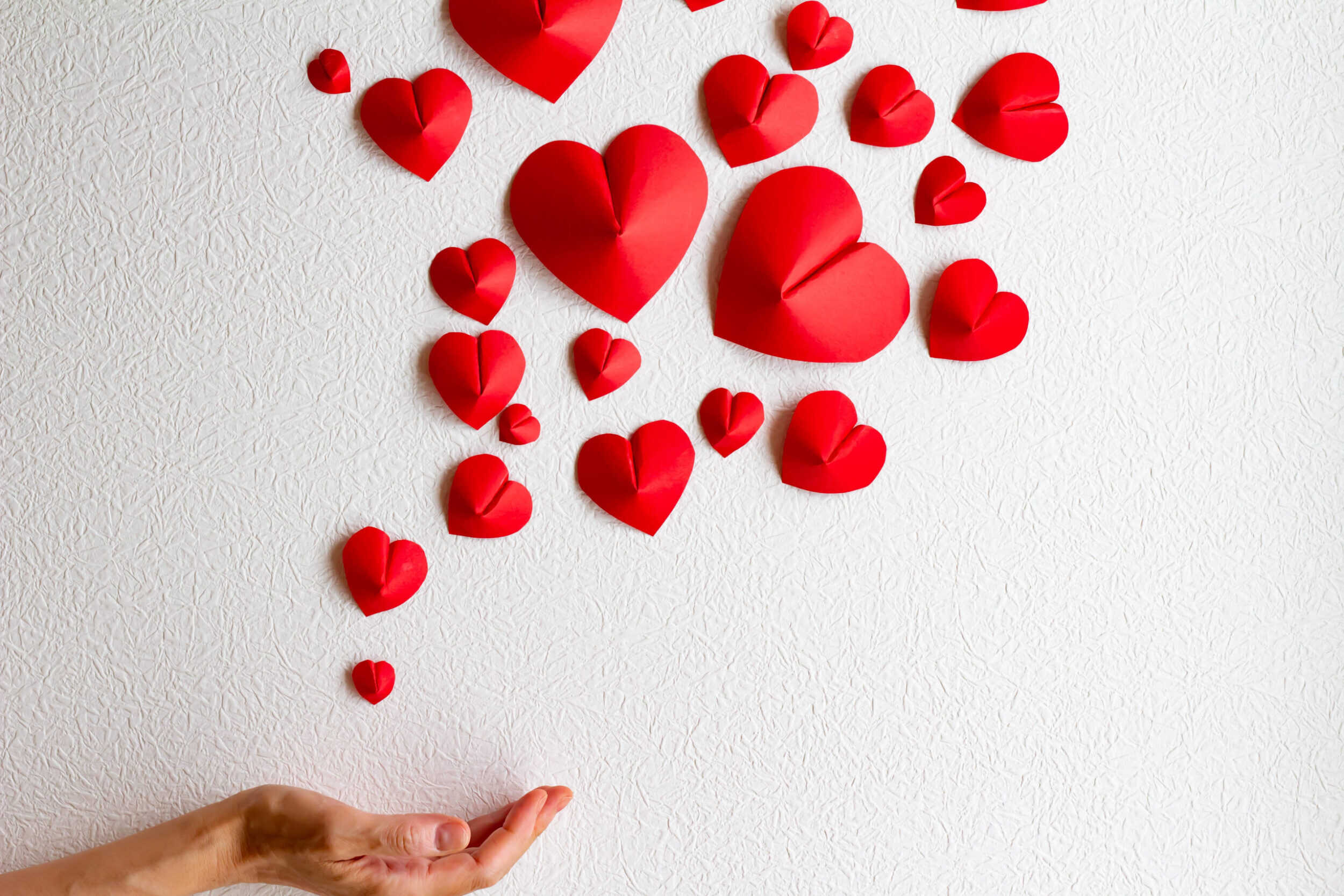 Heart-shaped folded paper on a white background.