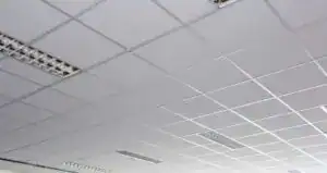 Ceiling tiles and drywall installation in an office space.