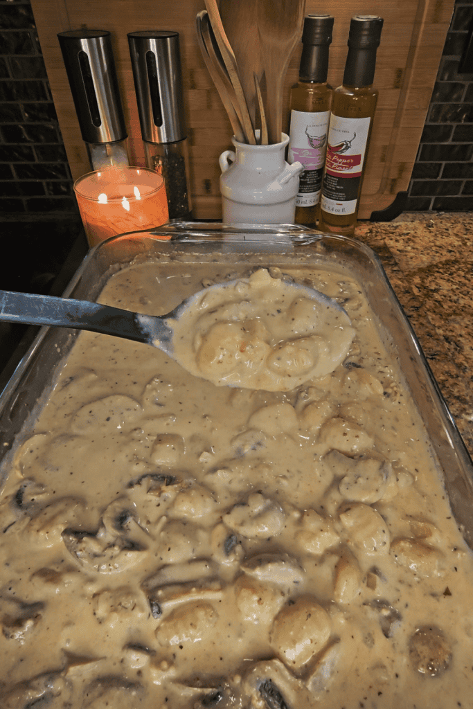 Creamy Boursin gnocchi in a baking dish with herbs and spices, ready to serve.