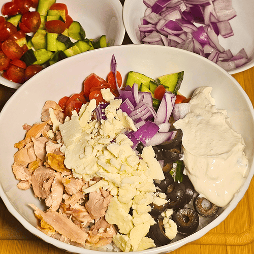 Greek Chicken Rice Bowl with vegetables and feta cheese.