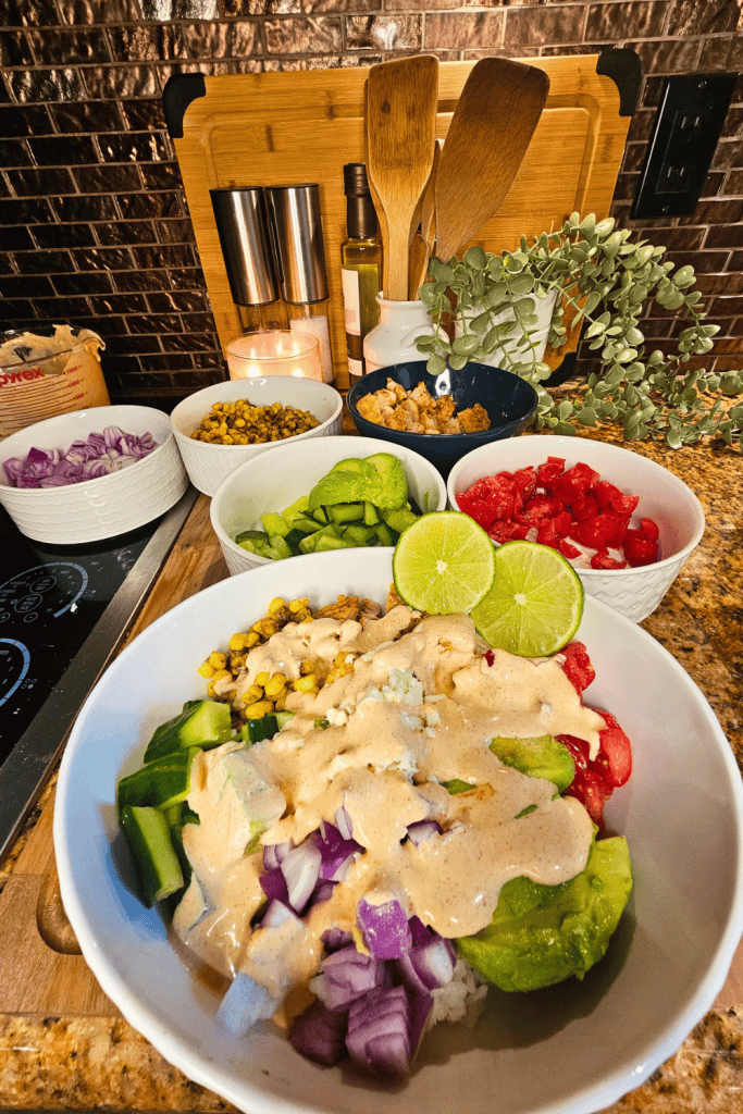 Healthy chicken and vegetable bowl with fresh toppings and lime for nutritious meals.
