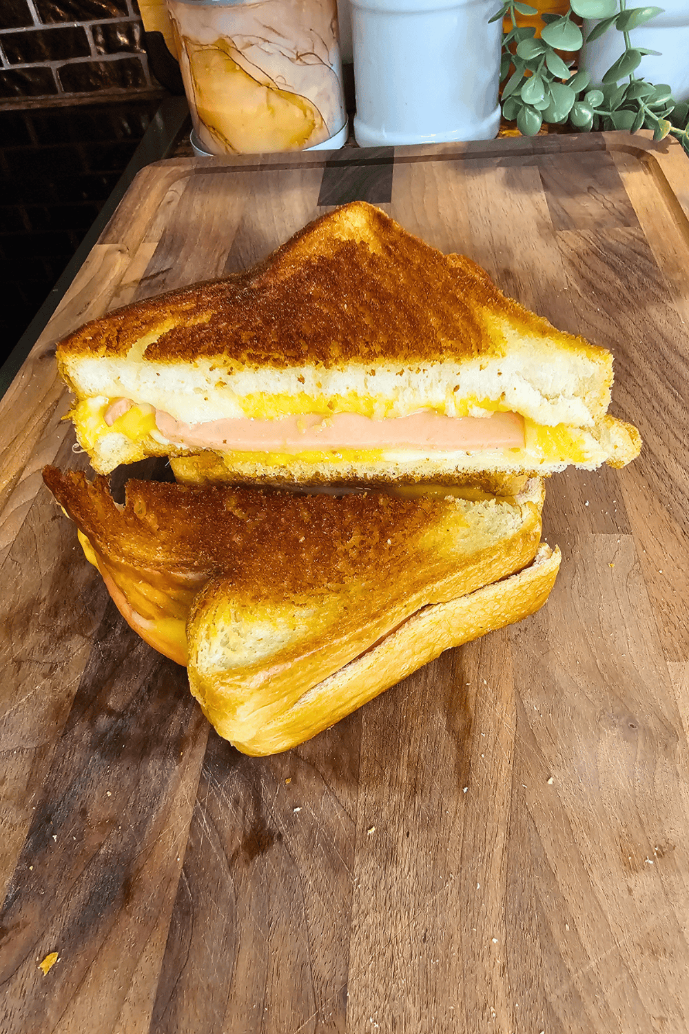 Delicious grilled cheese sandwich with ham and melted cheese on toasted bread.