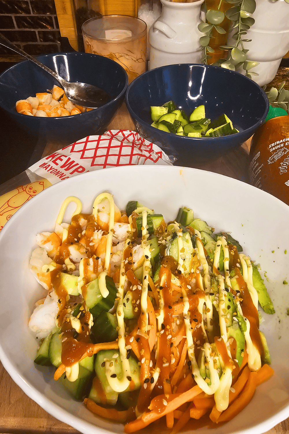 Fresh sushi rice bowl with avocado, carrots, and sauces for easy sushi bowls.