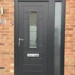 Stylish black front door with side window and modern design, ideal for enhancing home security and curb appeal.