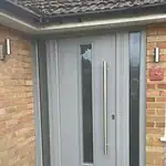 Modern PVC front door with vertical glass panel and brushed metal handle, fitted by CP Glazing Ltd.