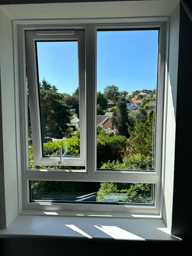 Modern UPVC double-glazed window with scenic view, installed by CP Glazing Ltd, enhancing home energy efficiency.