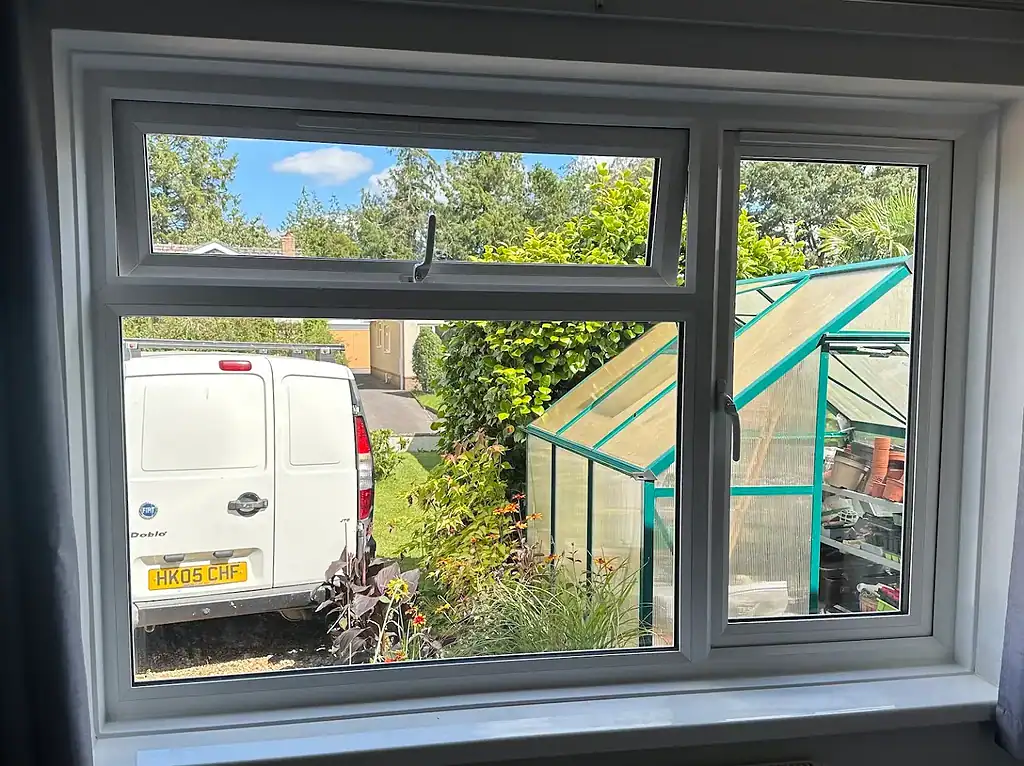 Smooth white uPVC double-glazed window with tilt and turn functionality, enhanced energy efficiency.