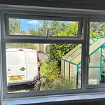Smooth white uPVC double-glazed window with tilt and turn functionality, enhanced energy efficiency.
