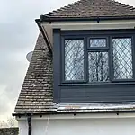 UPVC roof window installation with diamond leaded glass in a traditional home.