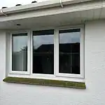 Modern white uPVC double-glazed sash window installation. Enhances home insulation and aesthetics.
