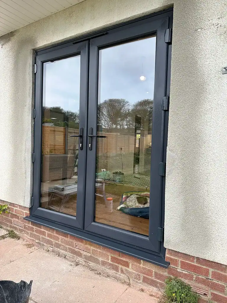 Double glazed grey PVC door, perfect for home security and insulation in the UK.