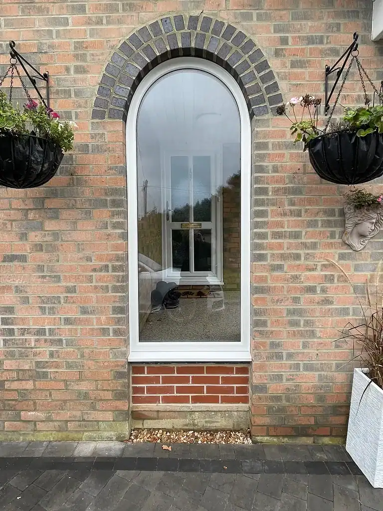 High-quality UPVC door with arched design and double glazing for enhanced security and insulation.