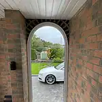 Modern arched PVC door with double glazing for enhanced security and insulation.